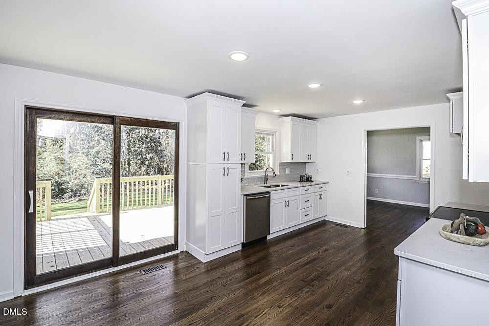805 River Road Selma, NC 27576 - Photo 21 of 40 a kitchen with a white stove top oven and white cabinets