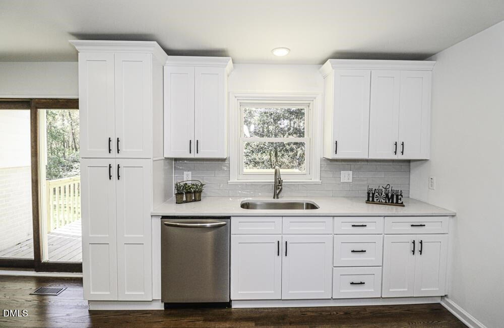 805 River Road Selma, NC 27576 - Photo 23 of 40 a kitchen with white cabinets and white appliances