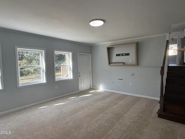 an empty room with windows and closet