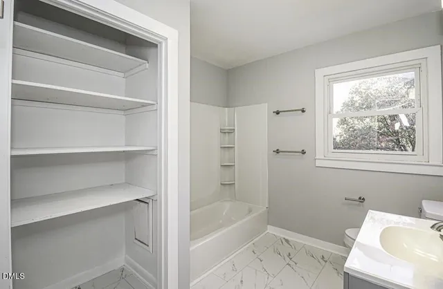 a bathroom with a bathtub and a toilet