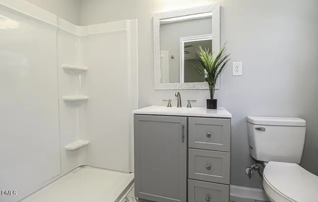 a bathroom with a sink a toilet and mirror