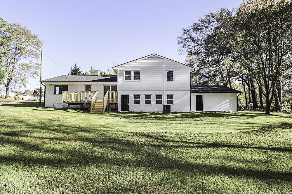 805 River Road Selma, NC 27576 - Photo 7 of 40 a front view of a house with a garden and trees