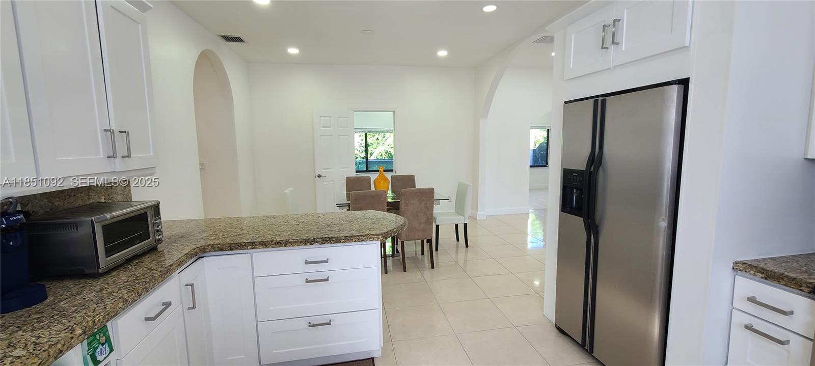 1721 Southwest 24th Terrace Miami, FL 33145 - Photo 26 of 80 a kitchen with stainless steel appliances granite countertop a refrigerator and a stove top oven