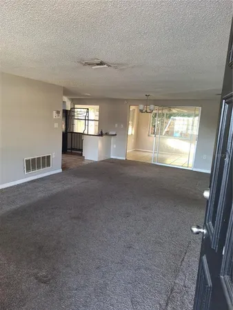 a view of empty room with stairs and windows