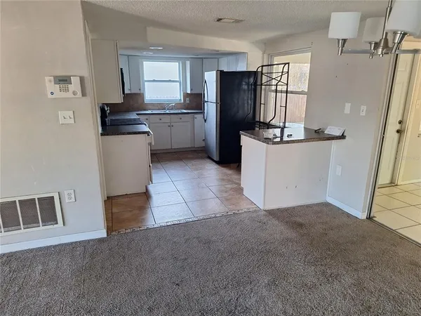 a kitchen with refrigerator and window