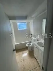 a bathroom with a sink a toilet and bathtub
