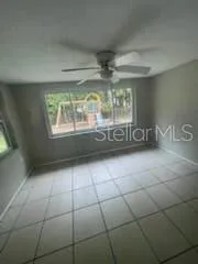 a room with a large window and chandelier