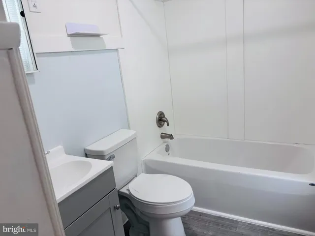 a bathroom with a sink toilet and bathtub
