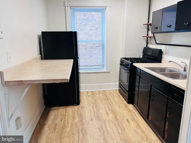 a kitchen with a sink and a stove top oven