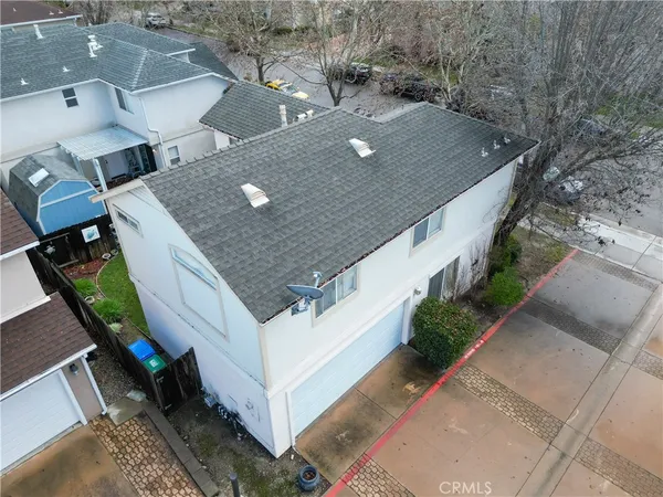 an aerial view of a house with a yard