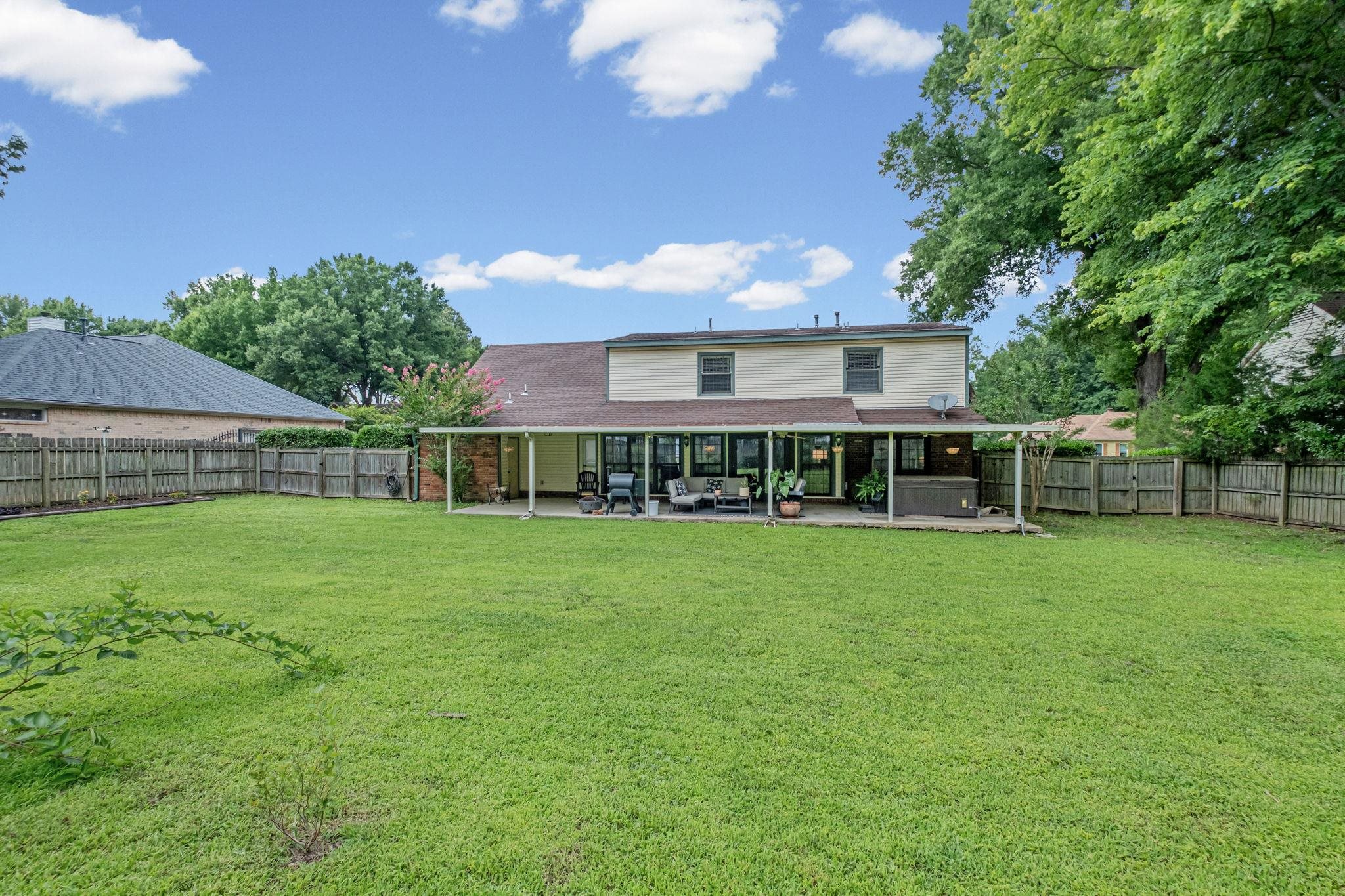 4729 Cedar Ridge Drive Millington, TN 38053 - Photo 40 of 40 Expansive backyard featuring a large green lawn, full privacy fencing, and mature trees