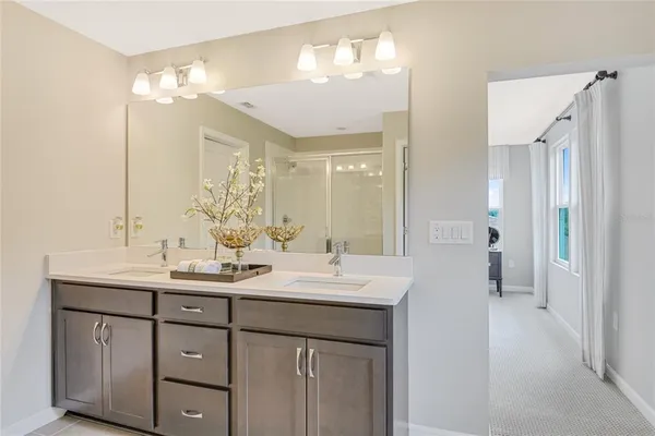 a bathroom with a double vanity sink and a mirror