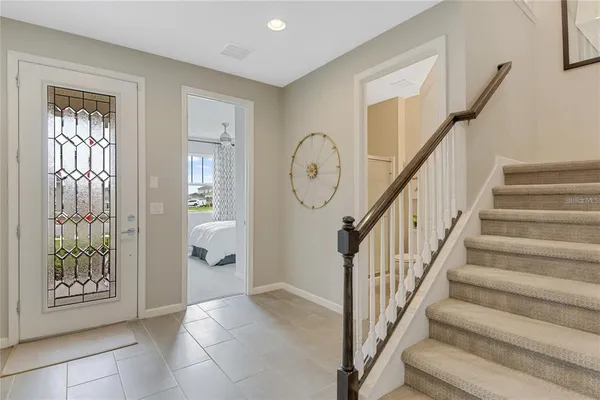 a view of a hallway with entryway wooden floor and front door