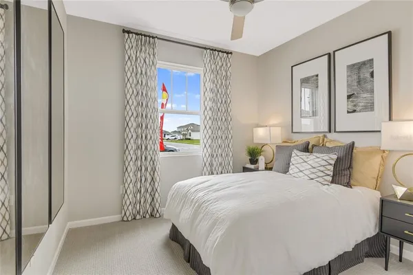 a bedroom with a large bed and a window