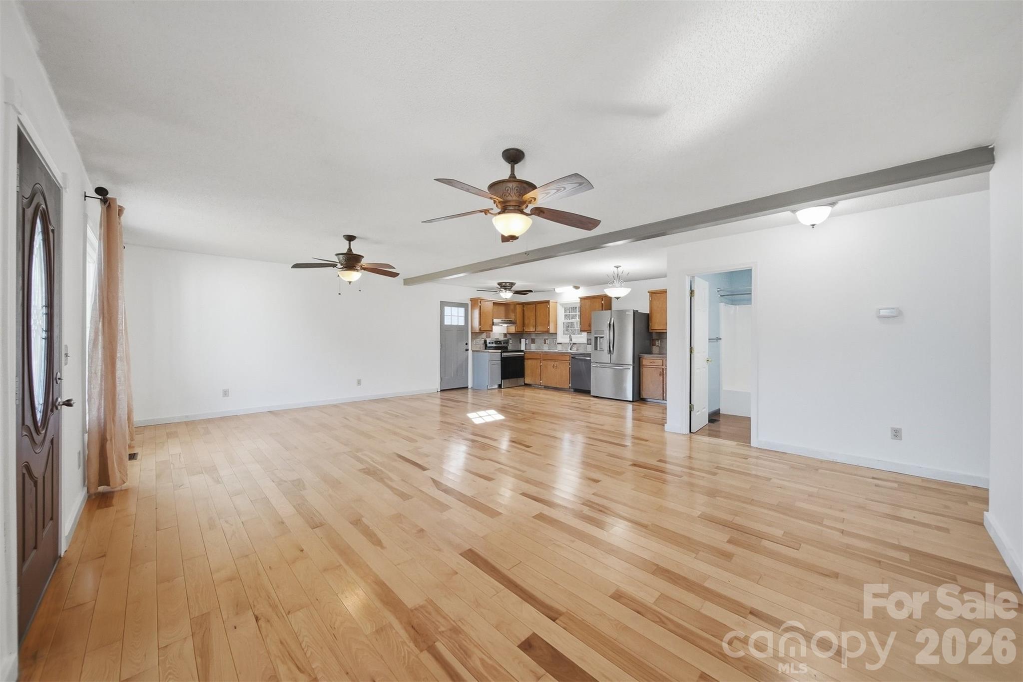 4771 Petra Mill Road Granite Falls, NC 28630 - Photo 17 of 46 a view of empty room with wooden floor and ceiling fan