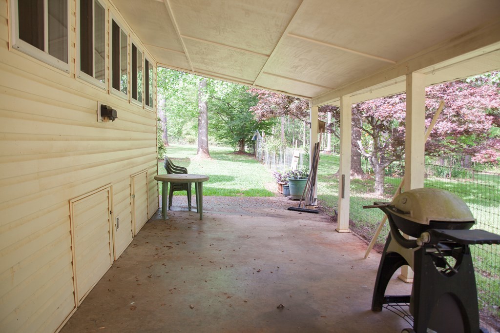 414 Homer Roberts Road Gray, GA 31032 - Photo 2 of 33 a view of a porch with furniture and a yard