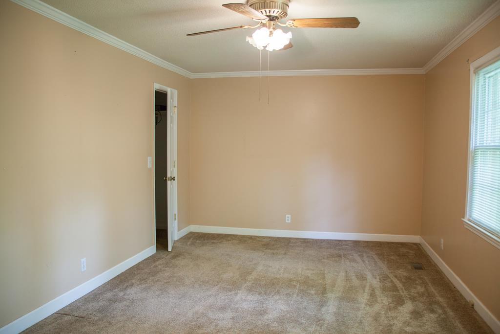 414 Homer Roberts Road Gray, GA 31032 - Photo 17 of 33 an empty room with windows and fan