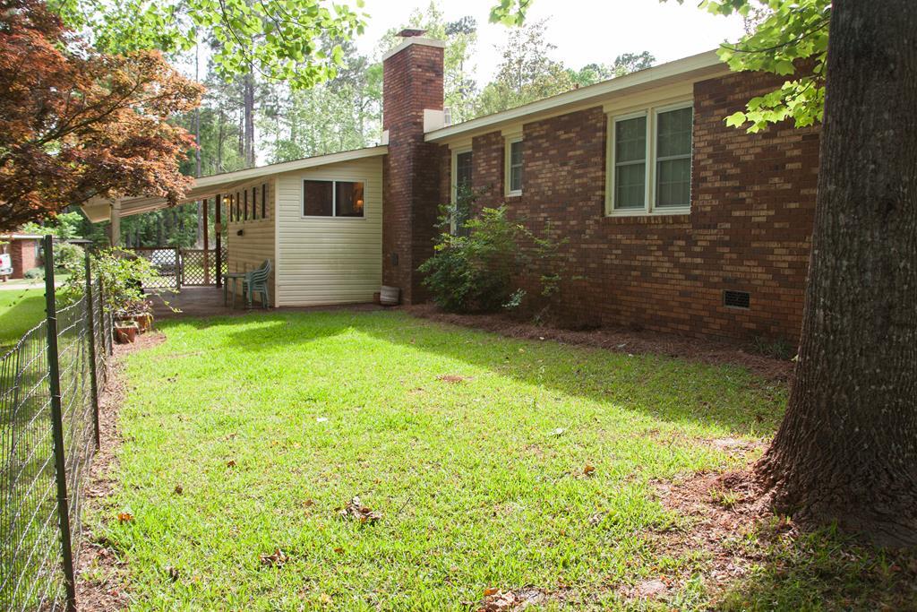 414 Homer Roberts Road Gray, GA 31032 - Photo 21 of 33 a backyard of a house with plants and large tree