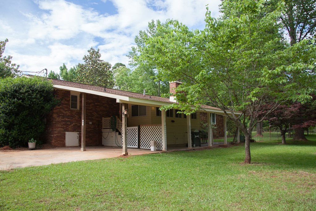 414 Homer Roberts Road Gray, GA 31032 - Photo 22 of 33 a view of a wooden house with a big yard and large trees
