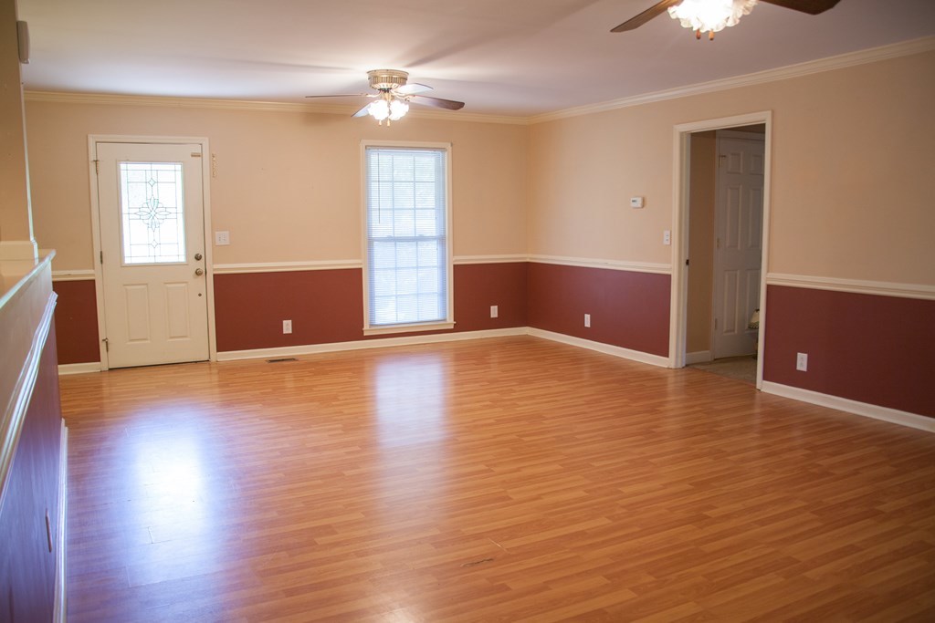 414 Homer Roberts Road Gray, GA 31032 - Photo 4 of 33 a view of livingroom with hardwood floor and ceiling fan