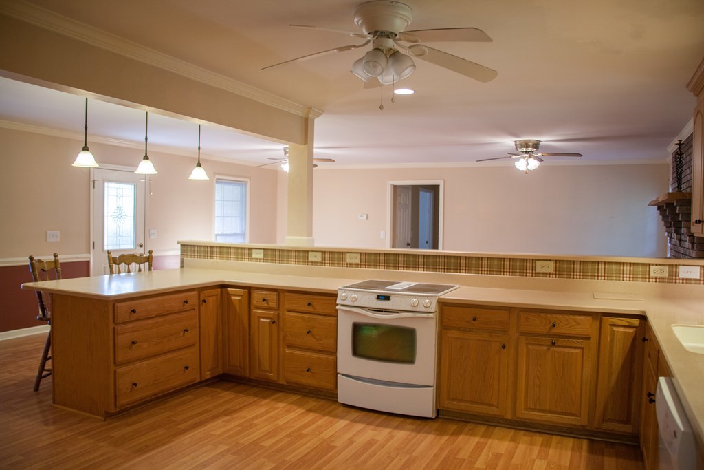 414 Homer Roberts Road Gray, GA 31032 - Photo 7 of 33 a kitchen with a stove a sink and a refrigerator