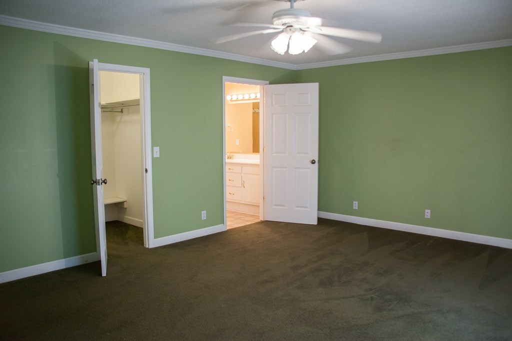 414 Homer Roberts Road Gray, GA 31032 - Photo 9 of 33 an empty room with closet and a chandelier fan