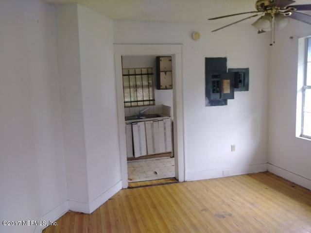 2022 Moncrief Road Jacksonville, FL 32209 - Photo 14 of 19 a view of an empty room with a fireplace and a window