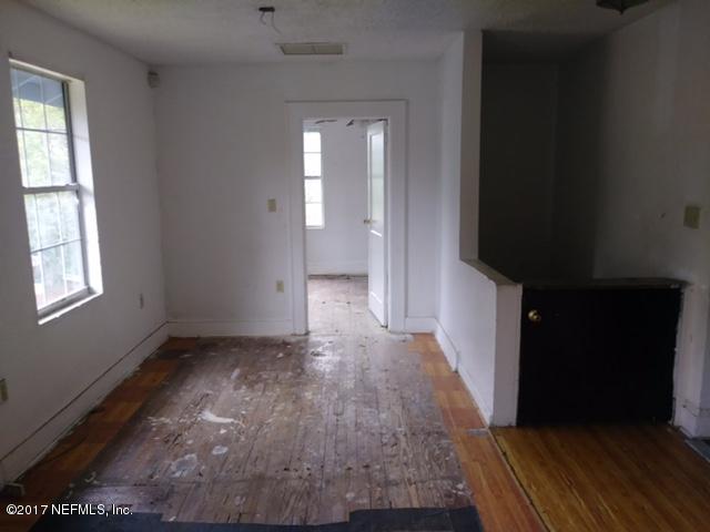 2022 Moncrief Road Jacksonville, FL 32209 - Photo 15 of 19 a view of a hallway with wooden floor and stairs