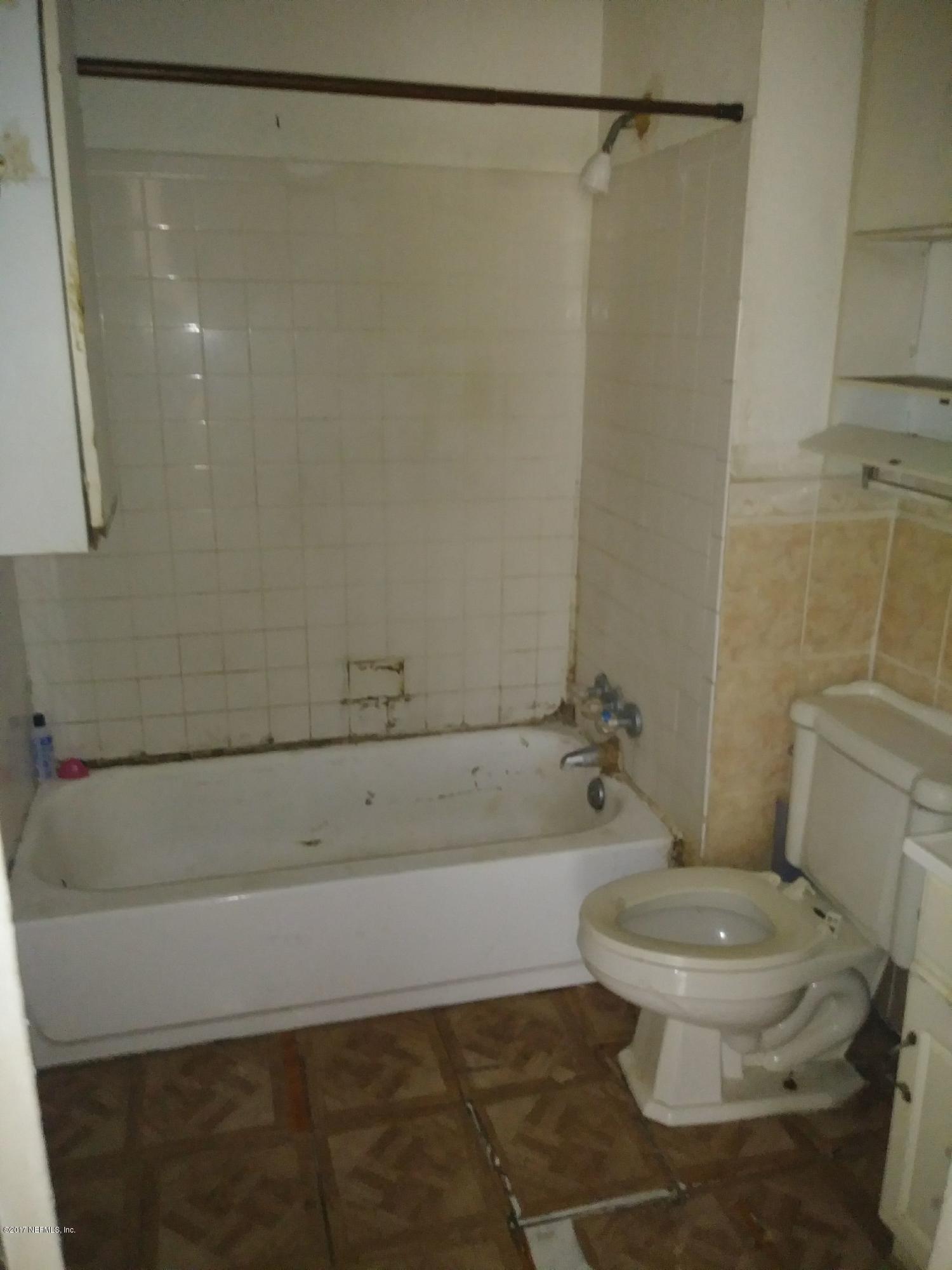 2022 Moncrief Road Jacksonville, FL 32209 - Photo 8 of 19 a bathroom with a toilet and a shower