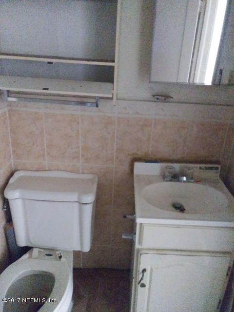 2022 Moncrief Road Jacksonville, FL 32209 - Photo 10 of 19 a bathroom with a toilet and a sink