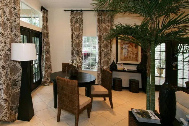 a view of a lake with a bench and trees around