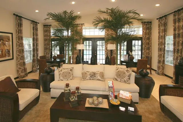 a living room with furniture and a potted plant