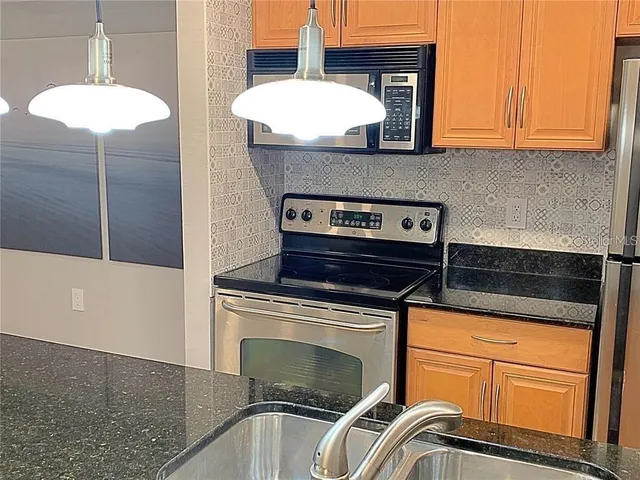 a stove top oven sitting inside of a kitchen