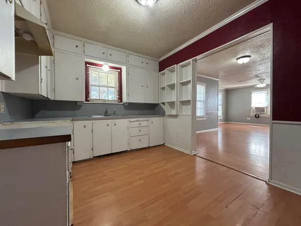a kitchen with granite countertop a sink cabinets and stainless steel appliances