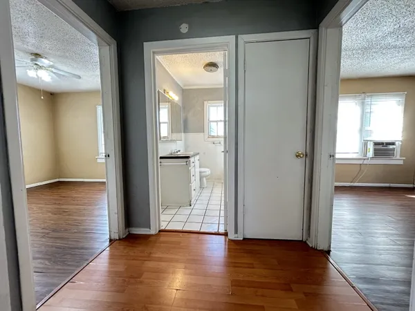a view of a hallway with wooden floor