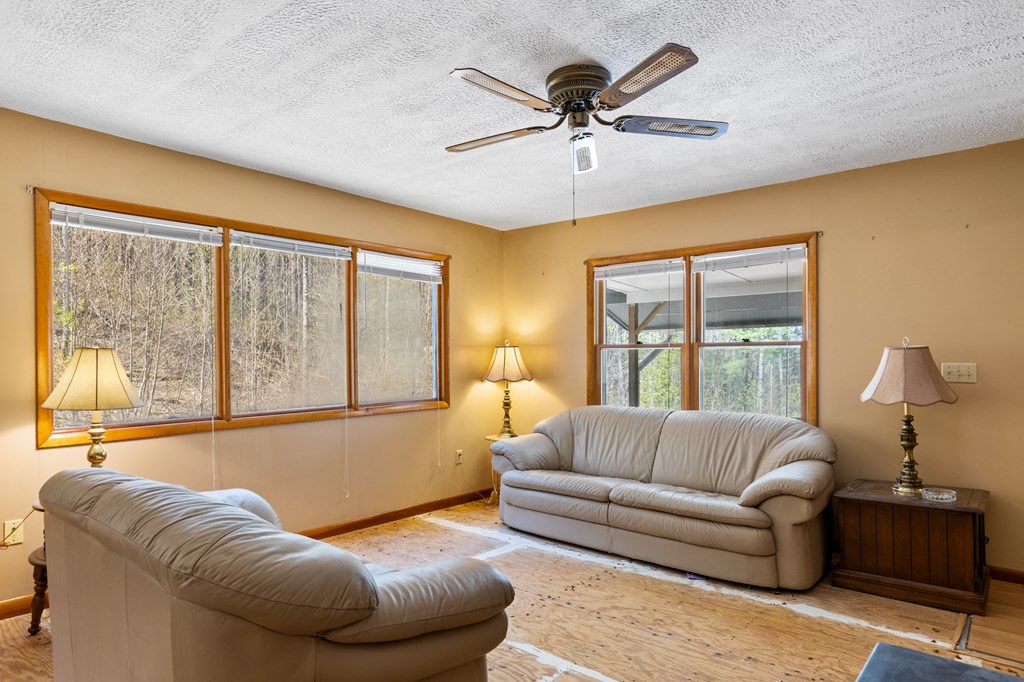 65 Caldwell Mountain Road Suches, GA 30572 - Photo 11 of 38 a living room with furniture and a large window