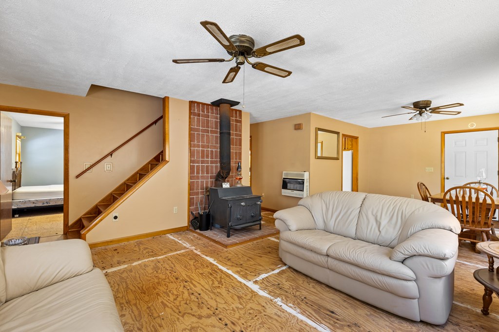 65 Caldwell Mountain Road Suches, GA 30572 - Photo 12 of 38 a living room with furniture ceiling fan and a rug