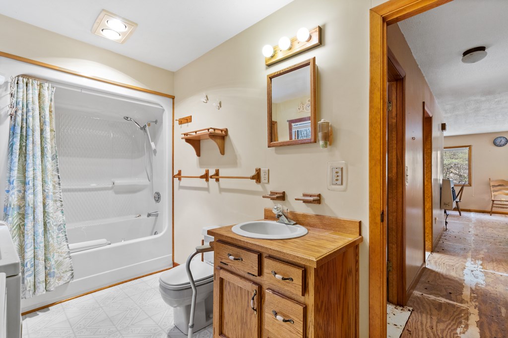 65 Caldwell Mountain Road Suches, GA 30572 - Photo 15 of 38 a bathroom with a sink mirror and a shower