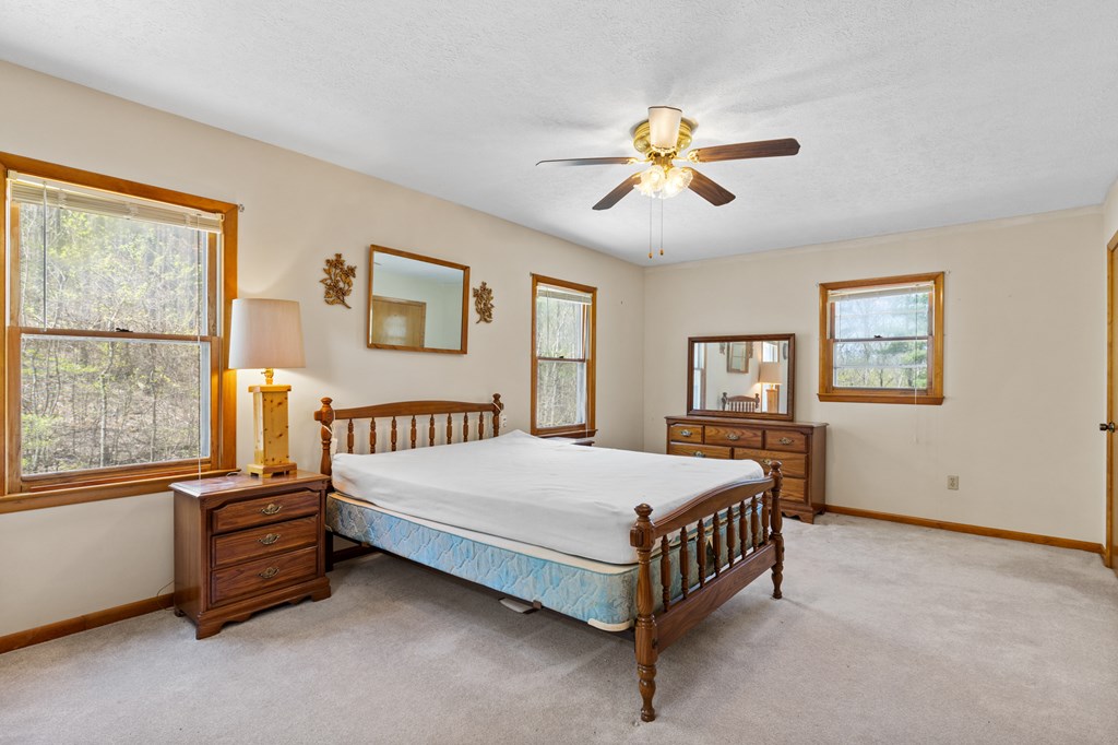 65 Caldwell Mountain Road Suches, GA 30572 - Photo 18 of 38 a bedroom with a bed and a window