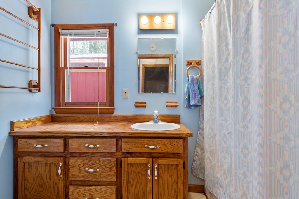 65 Caldwell Mountain Road Suches, GA 30572 - Photo 20 of 38 a bathroom with a sink and a mirror