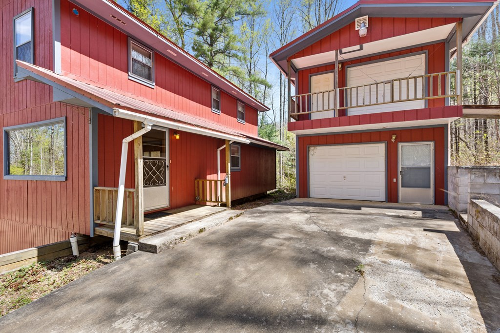 65 Caldwell Mountain Road Suches, GA 30572 - Photo 2 of 38 a view of a house with a garage and wooden fence