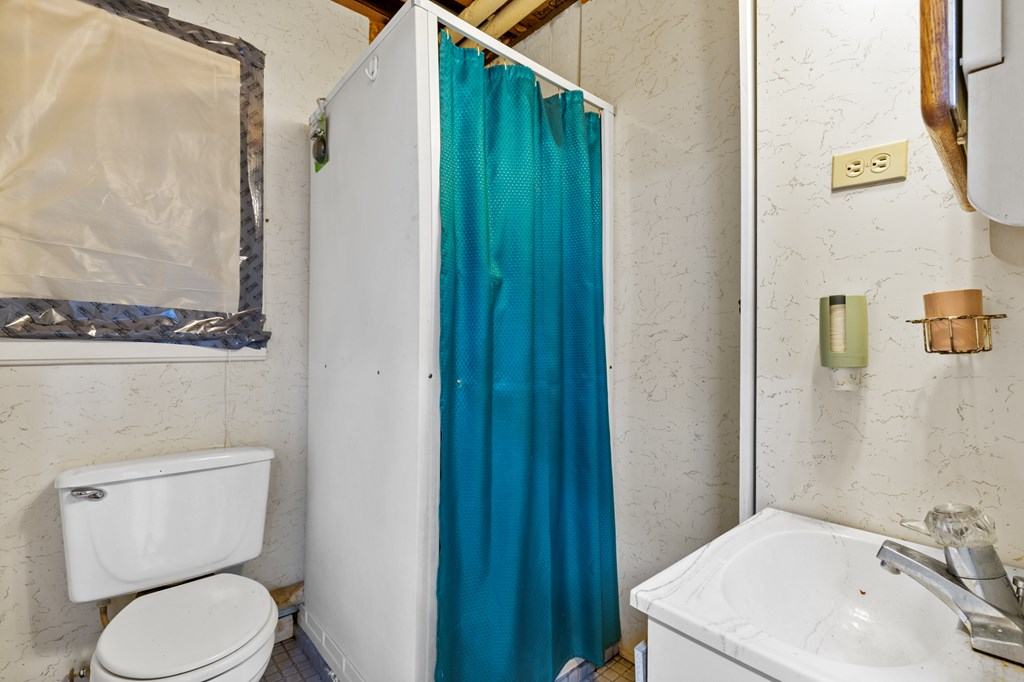 65 Caldwell Mountain Road Suches, GA 30572 - Photo 27 of 38 a white toilet sitting next to a bathroom sink