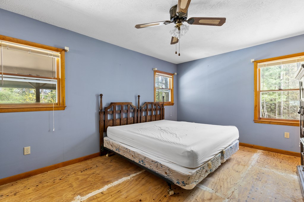 65 Caldwell Mountain Road Suches, GA 30572 - Photo 3 of 38 a bed sitting in a bedroom next to a window