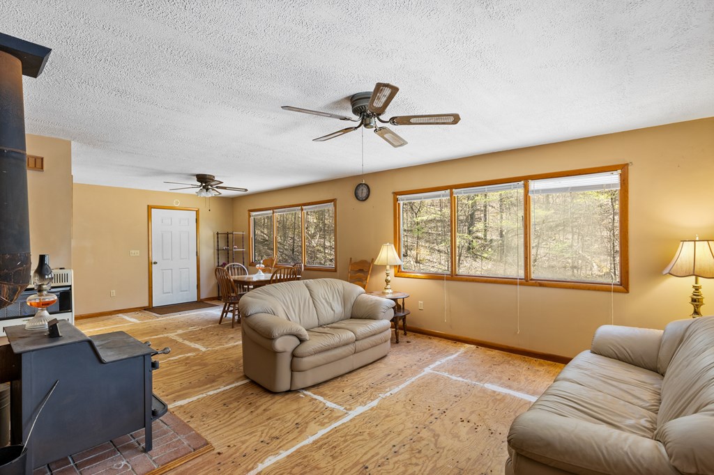 65 Caldwell Mountain Road Suches, GA 30572 - Photo 6 of 38 a living room with furniture and a large window