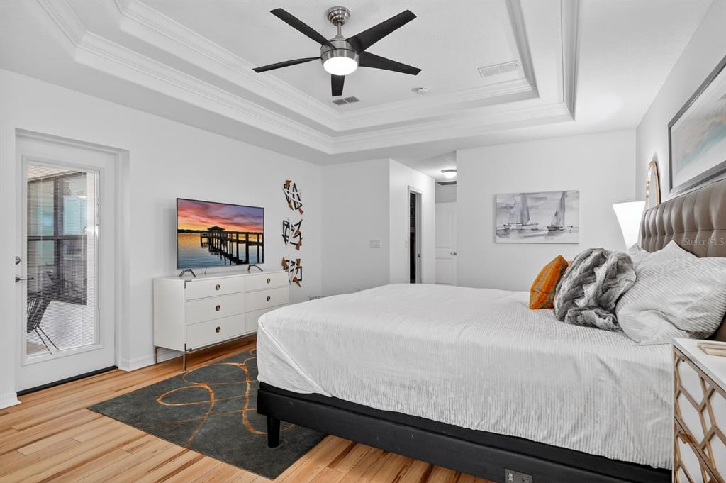 77 Apian Way Ormond Beach, FL 32174 - Photo 15 of 35 a bedroom with a bed and a flat screen tv