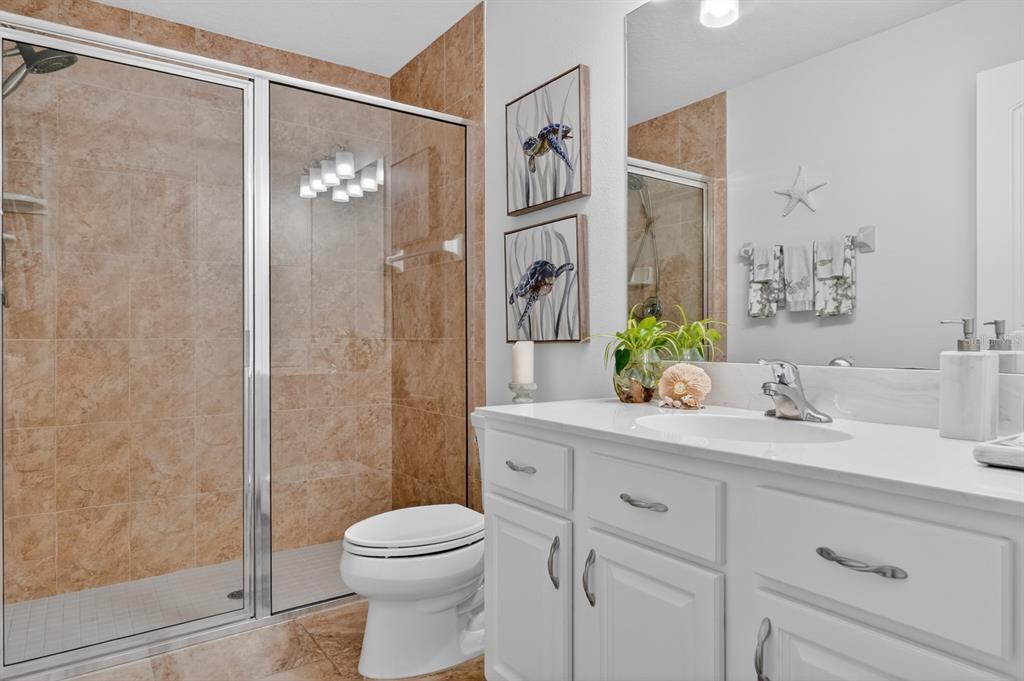 77 Apian Way Ormond Beach, FL 32174 - Photo 21 of 35 a bathroom with a sink a toilet and shower