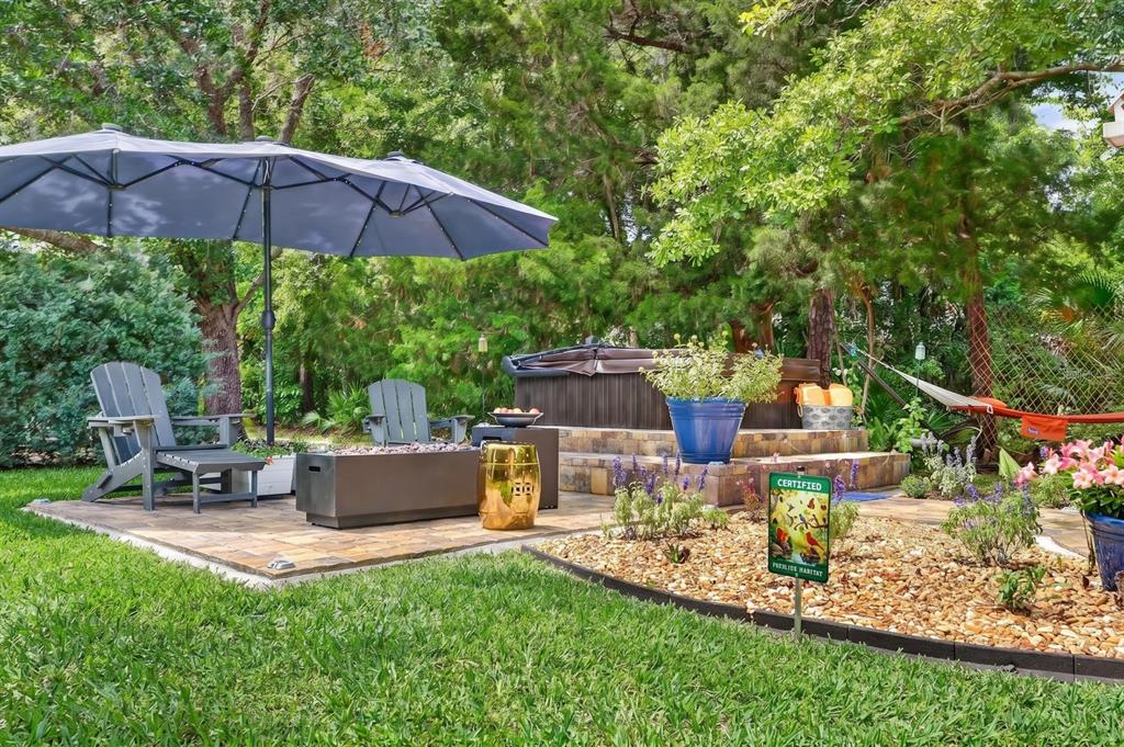 77 Apian Way Ormond Beach, FL 32174 - Photo 24 of 35 a view of a chair and table of the garden