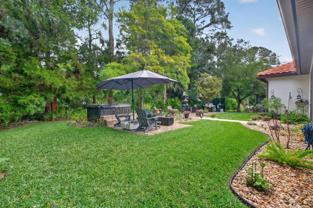 77 Apian Way Ormond Beach, FL 32174 - Photo 27 of 35 a view of a table and chairs under an umbrella