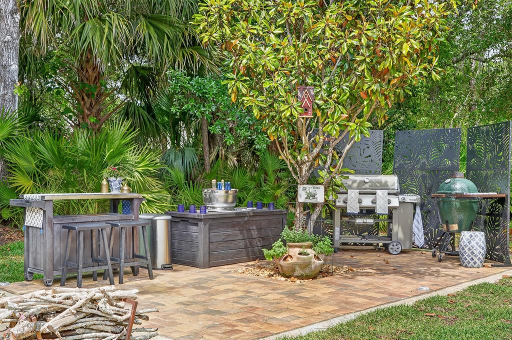 77 Apian Way Ormond Beach, FL 32174 - Photo 29 of 35 a view of a patio with table and chairs and wooden fence