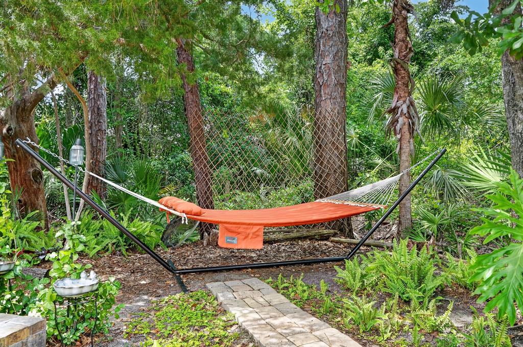 77 Apian Way Ormond Beach, FL 32174 - Photo 31 of 35 a wooden bench sitting in a forest